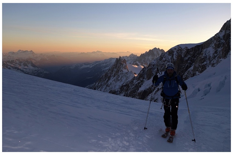 ski tourer at sunrise leaving behing the grands mulets hut on his way to the top of mont blanc